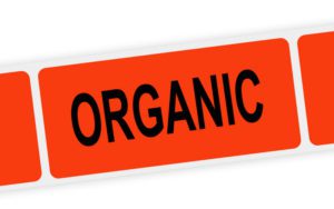 A florescent-red adhesive label with the word 'Organic' on it